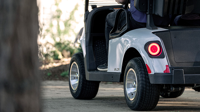 A rear view of a white E-Z-GO golf cart.