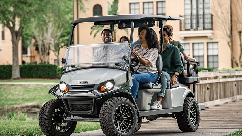 A group of friends ride in their E-Z-GO golf cart.