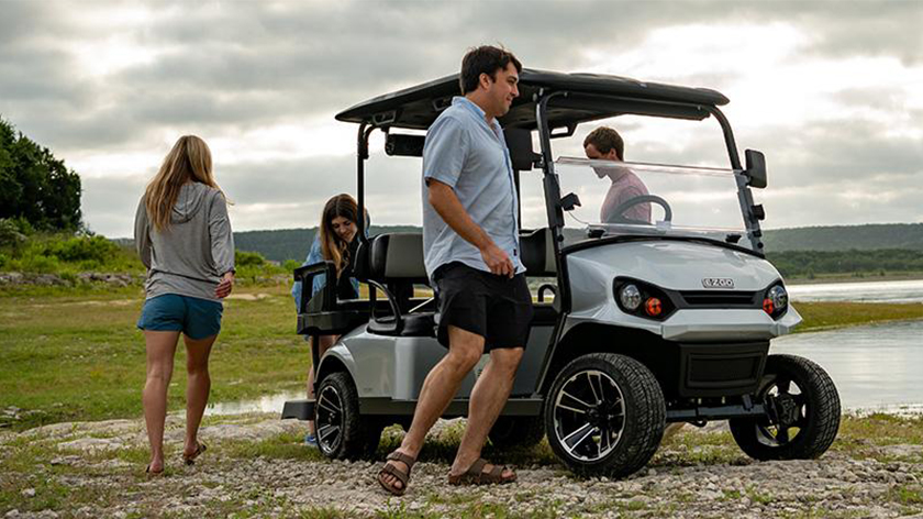 Passengers depart their E-Z-GO golf cart to enjoy nature.