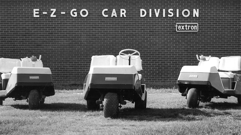 A black and white image of E-Z-GO golf carts outside of the E-Z-GO factory in Augusta, GA