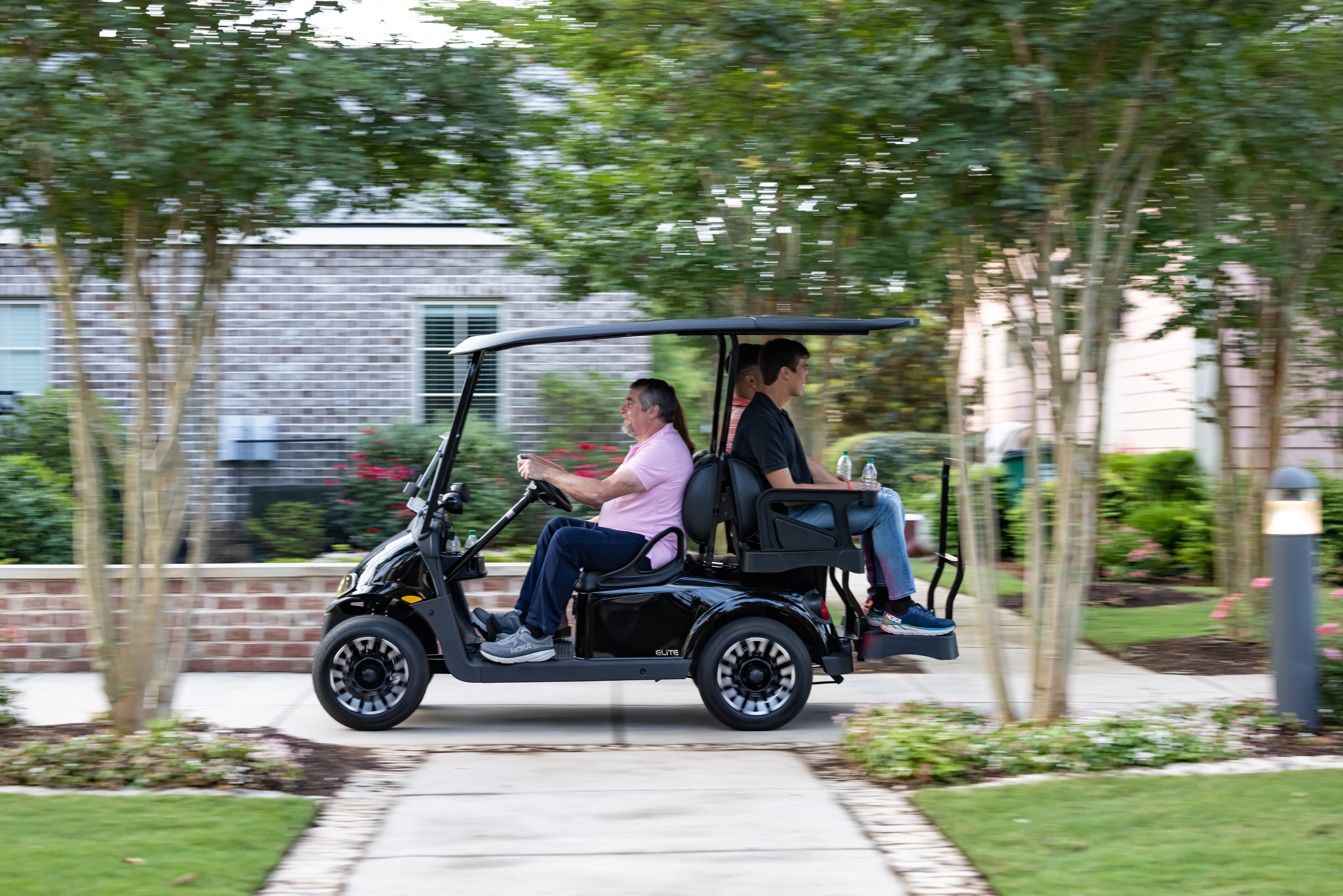 Friends riding E-Z-GO golf cart