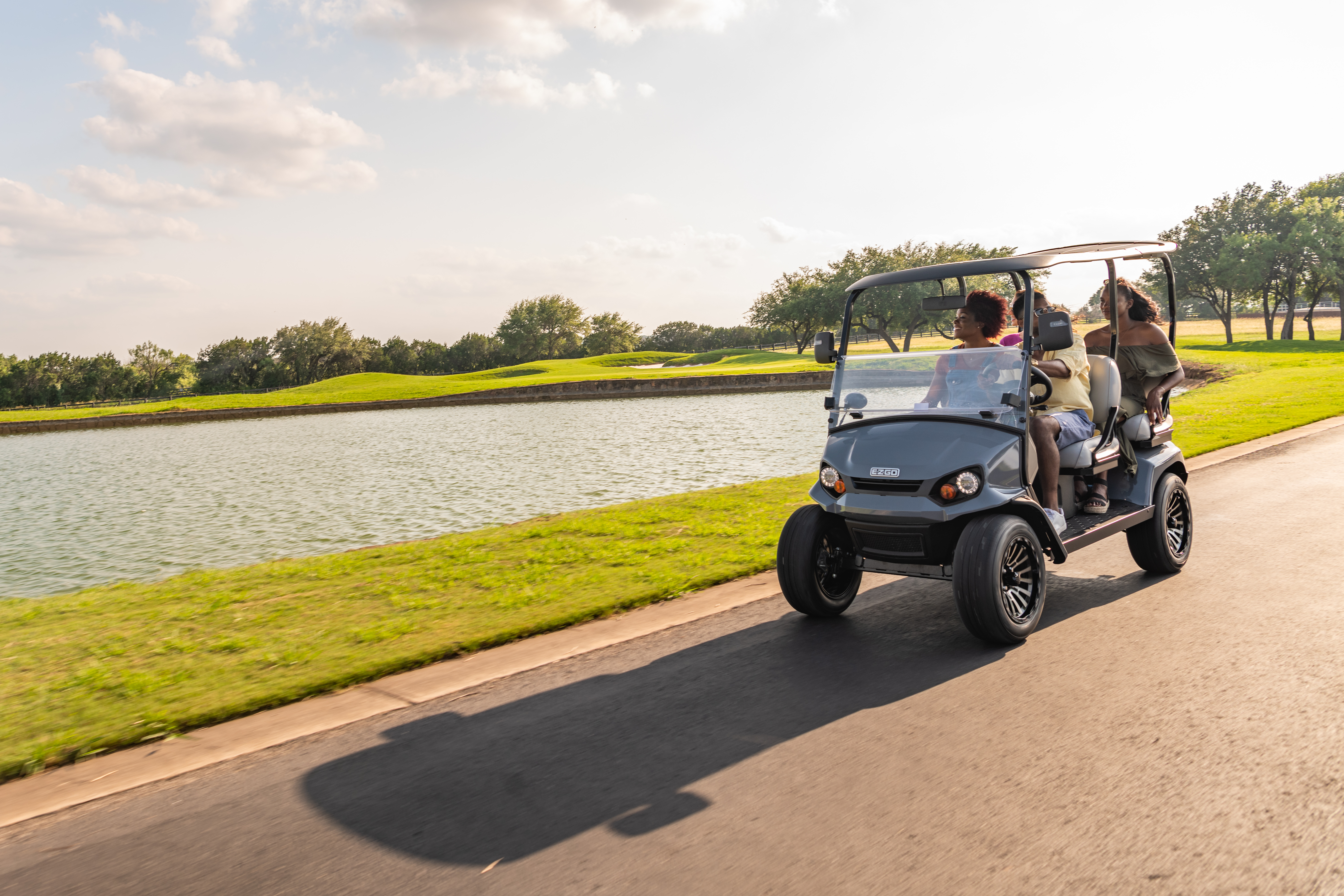 Friends riding E-Z-GO Liberty golf cart