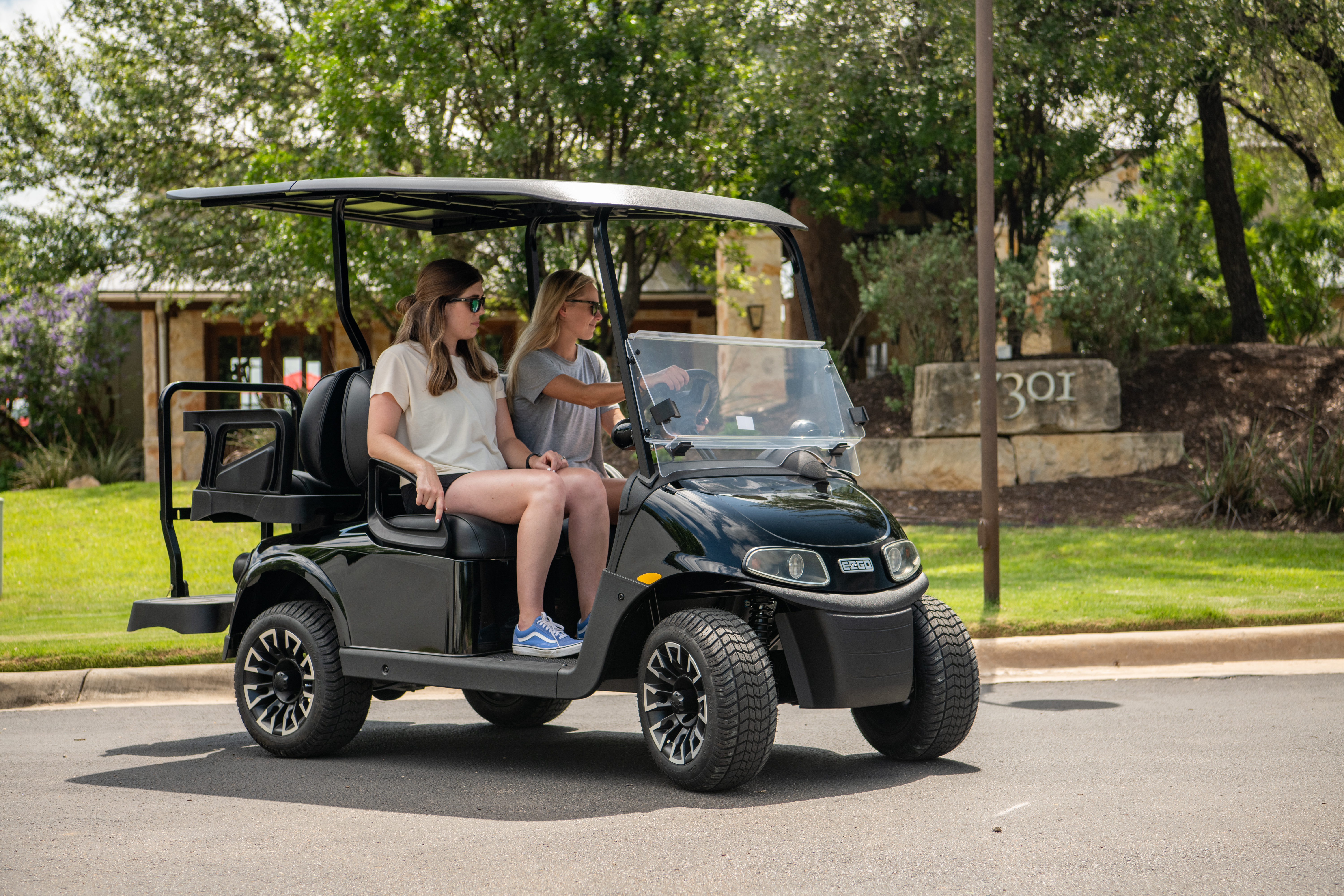 Girls riding E-Z-GO golf cart