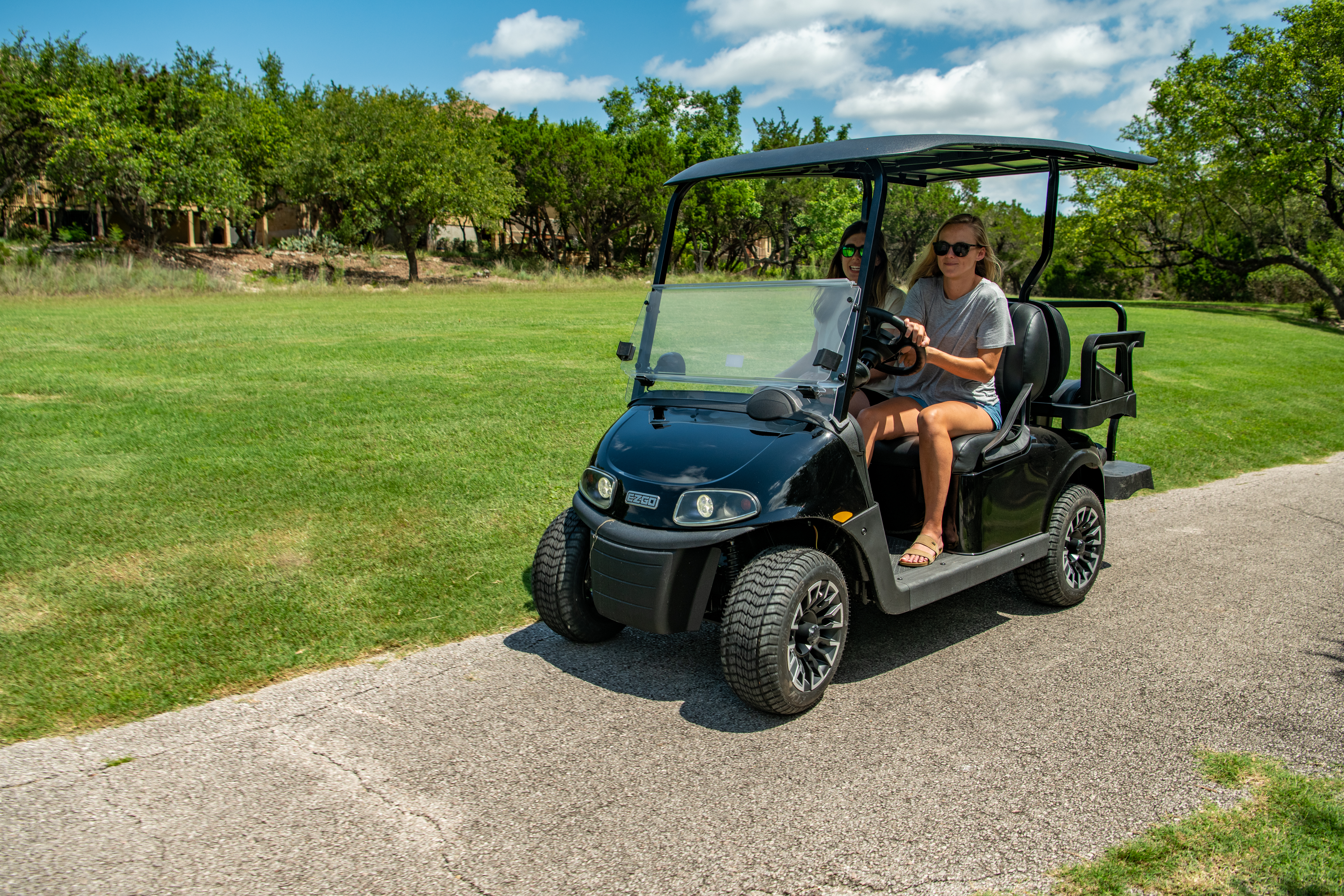 Golfers riding E-Z-GO golf cart