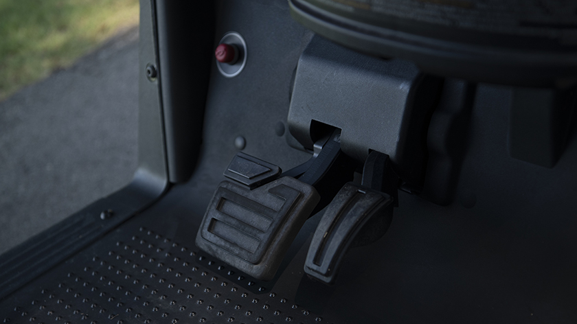 A close-up view of the hanging pedals in an E-Z-GO Freedom RXV golf cart.