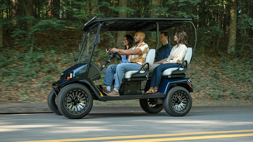 Liberty LSV driving down the road with 4 passengers