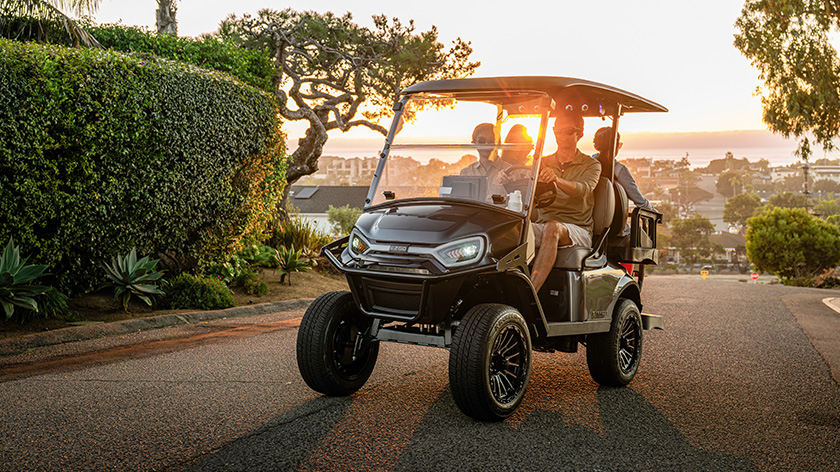 Express 4 driving with LED headlights and sunset in the background and shrubs