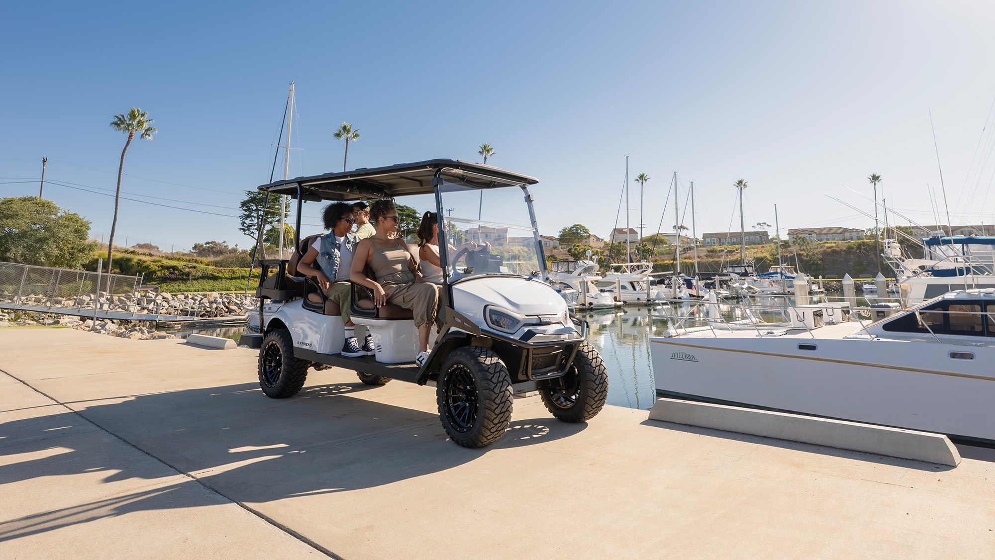 Express 6 driving past a marina/harbor