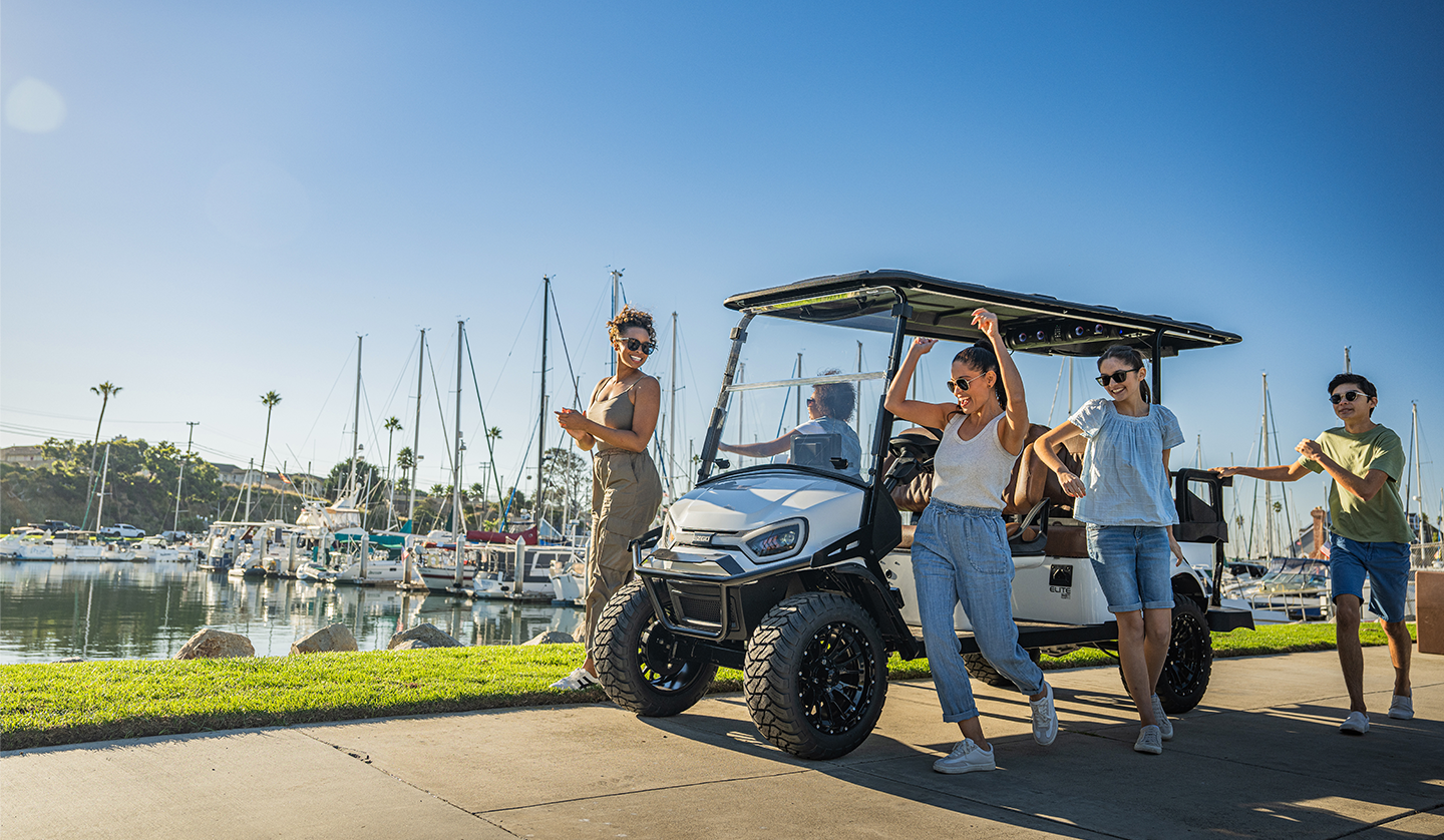 Express 6 with LED headlights sitting in front of a marina/harbor with sailboats in the background