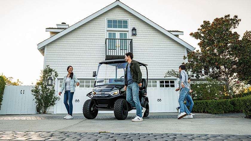 Liberty LSV parked in front of a garage with LED headlights