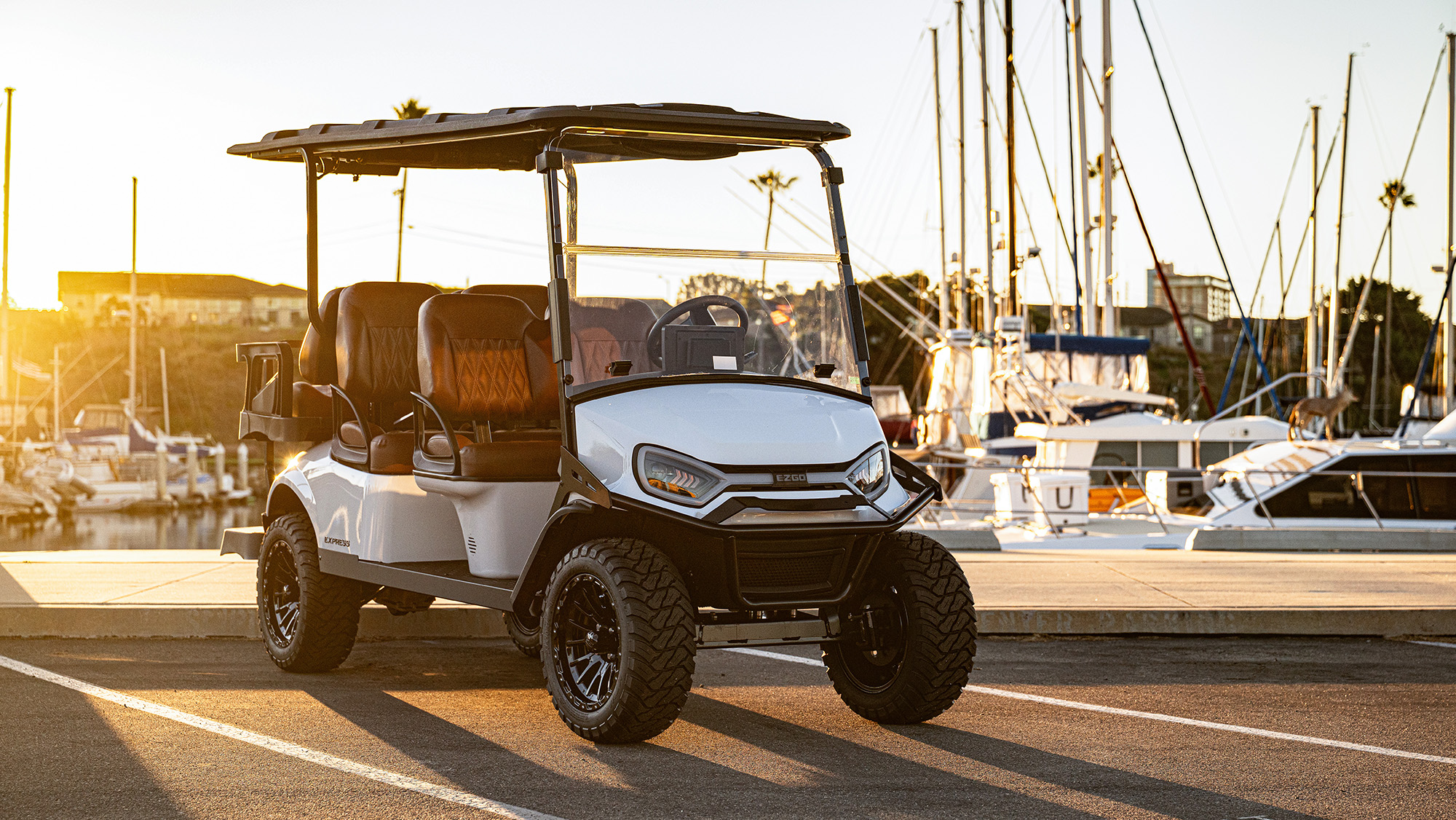 Express 6 sitting in front of a harbor/marina with sail boats in the background