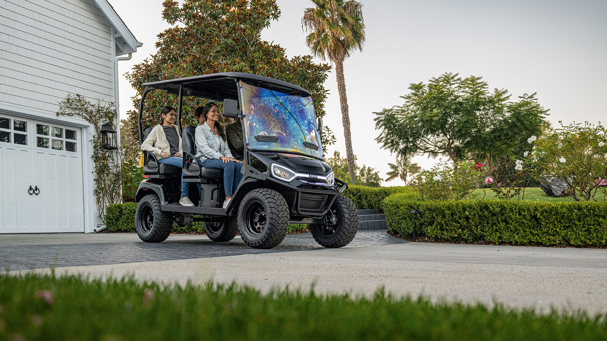 Liberty LSV in a driveway with a family of 4 about to drive off