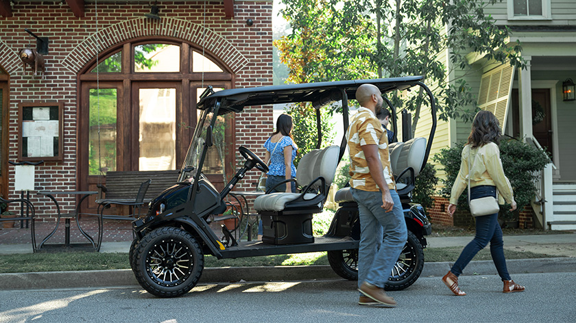 Group of 4 getting out of their Liberty LSV to go into a store