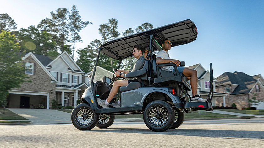RXV 4 electric golf cart driving in a neighborhood