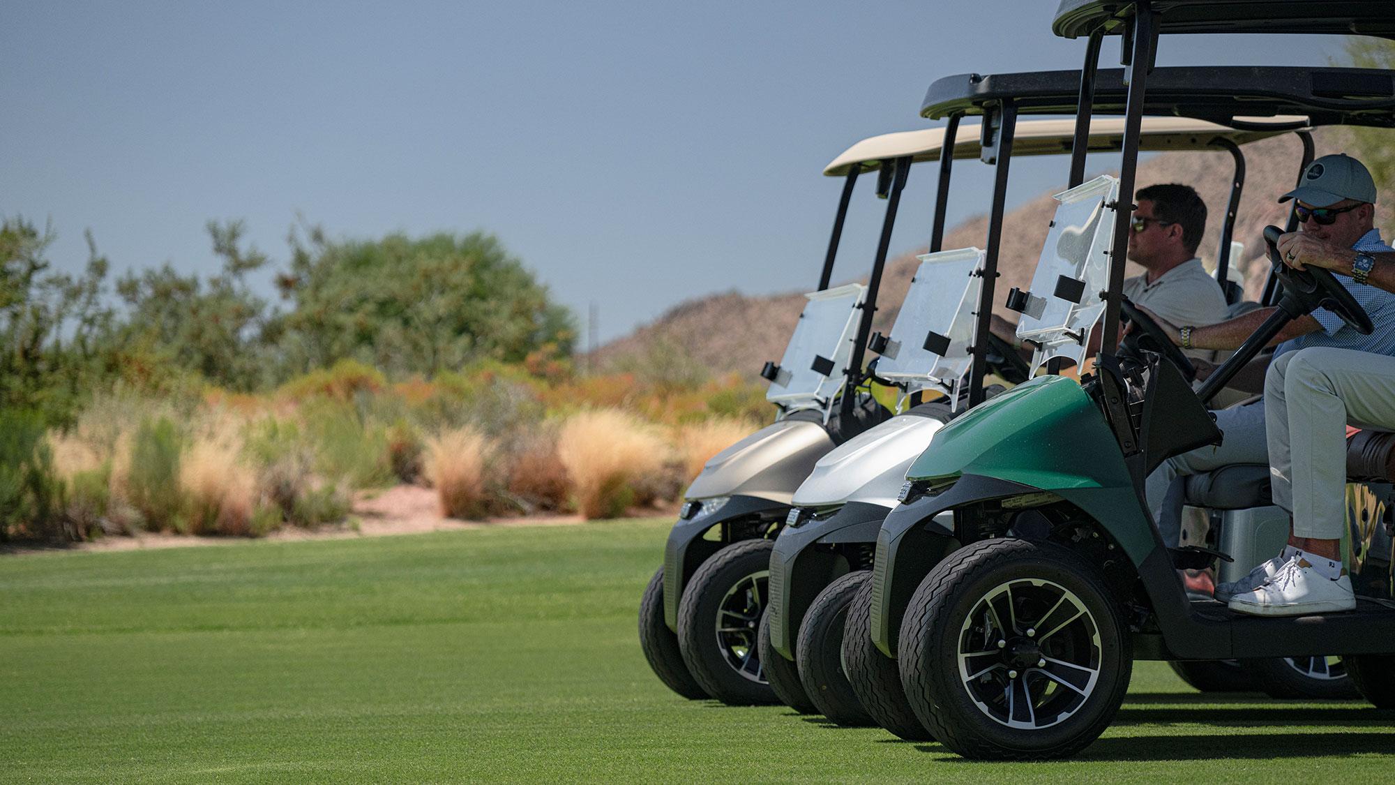 Group of 3 E-Z-GO golf carts on a golf course