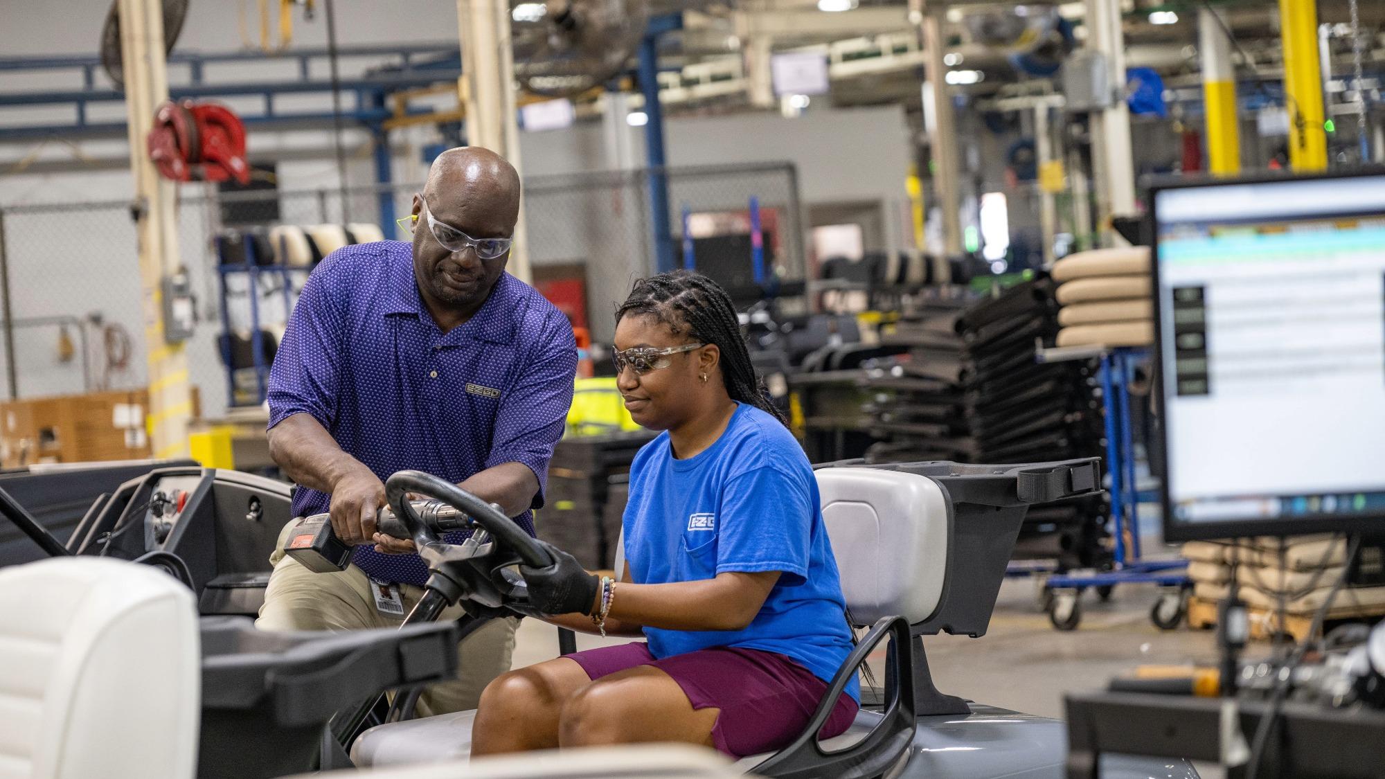 E-Z-GO manufacturing team member assembling a vehicle in the Augusta, Georgia production facility, demonstrating craftsmanship and quality-focused vehicle manufacturing