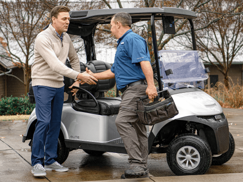 E-Z-GO Technician shaking hands with a happy E-Z-GO customer after a maintenance service.