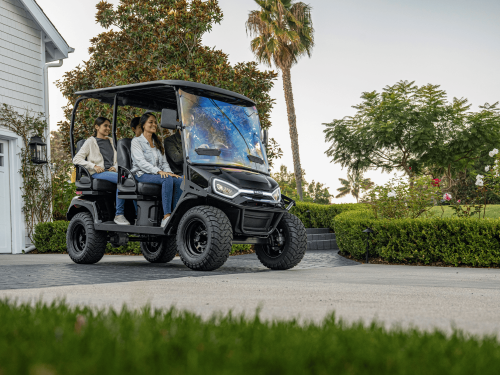 Liberty LSV in a driveway with a family of 4 about to drive off