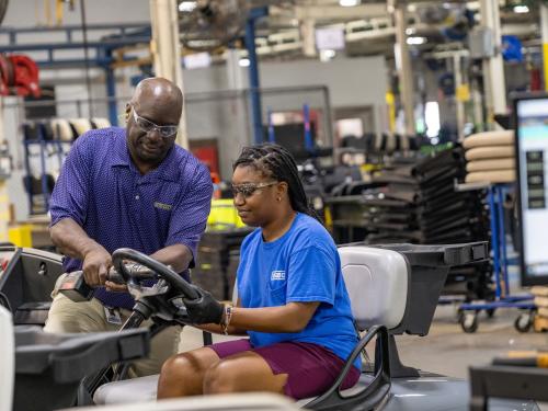 E-Z-GO manufacturing team member assembling a vehicle in the Augusta, Georgia production facility, demonstrating craftsmanship and quality-focused vehicle manufacturing
